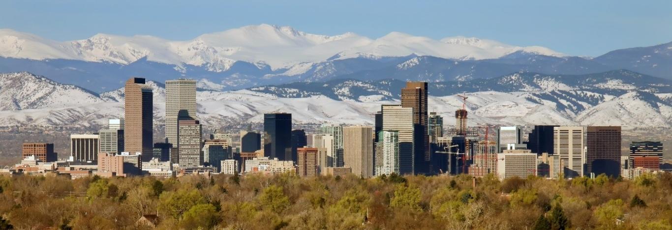 Mountains and city skyline in Denver, CO.