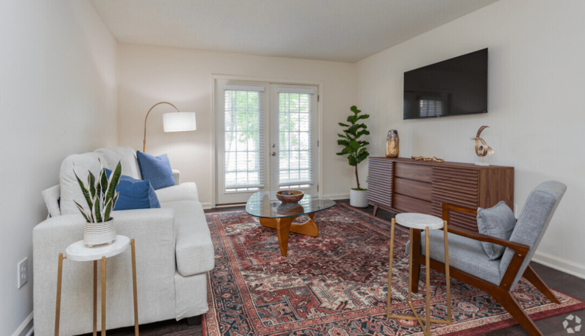 A living room at The Retreat at Copper Creek is lit by sunlight filtering through the window.