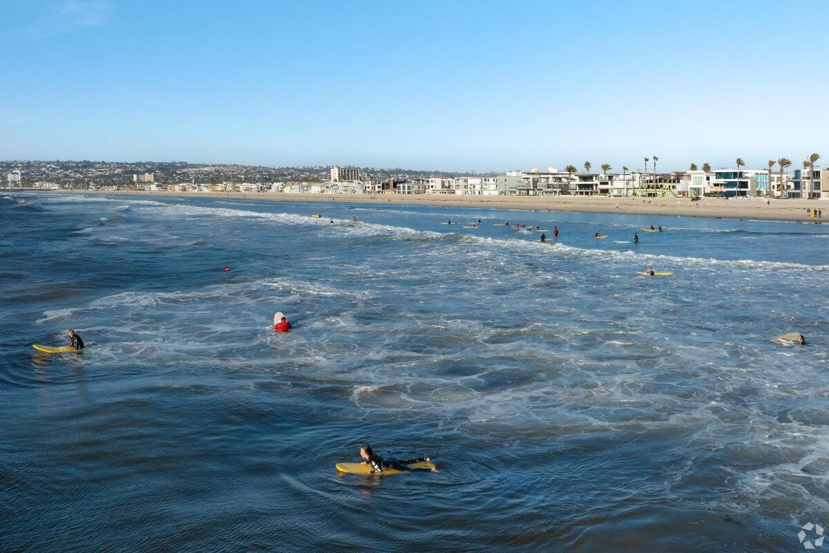 Beachgoers at Mission Beach enjoy bodyboarding.