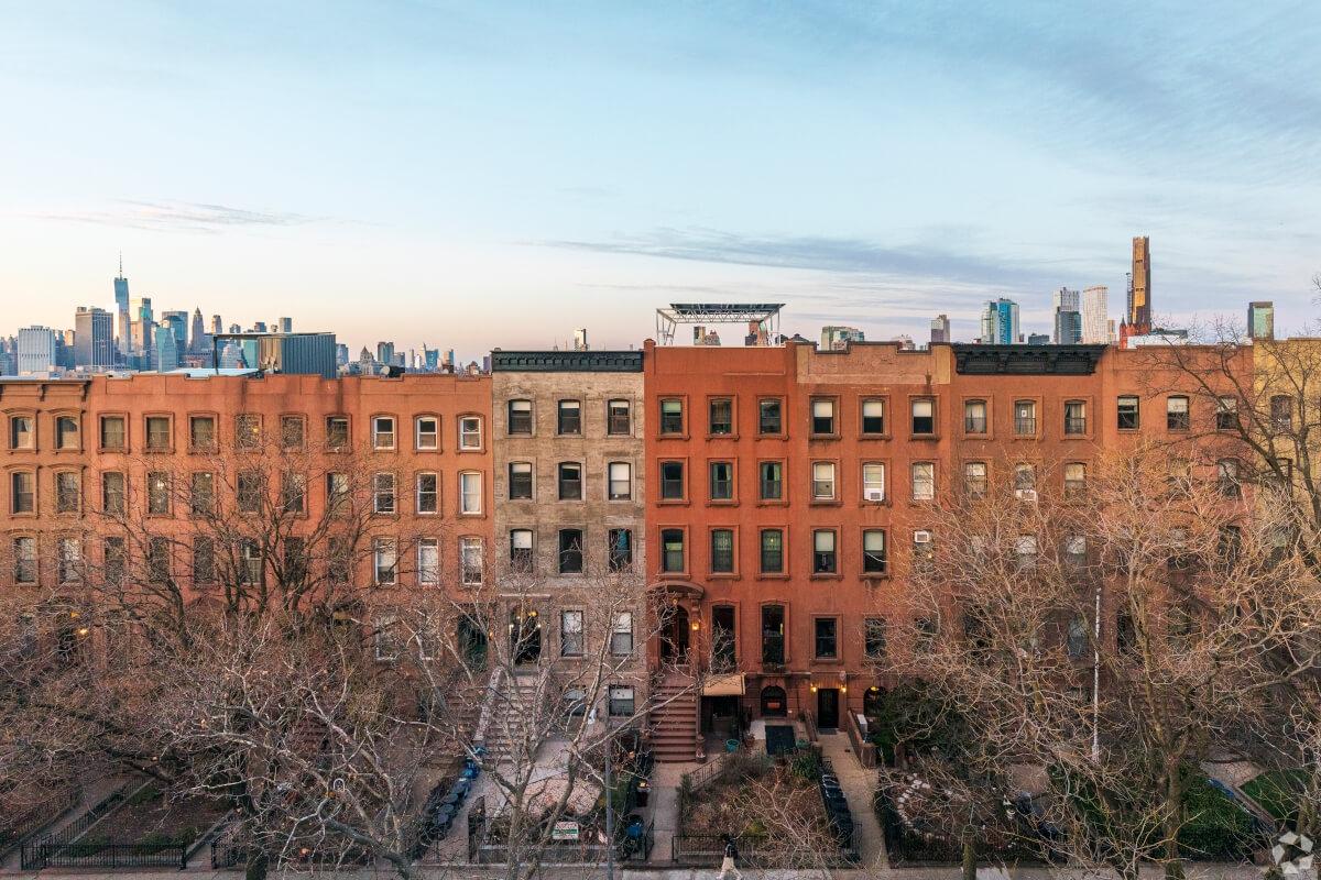 The Manhattan skyline peeks out from behind row homes in Carroll Gardens.