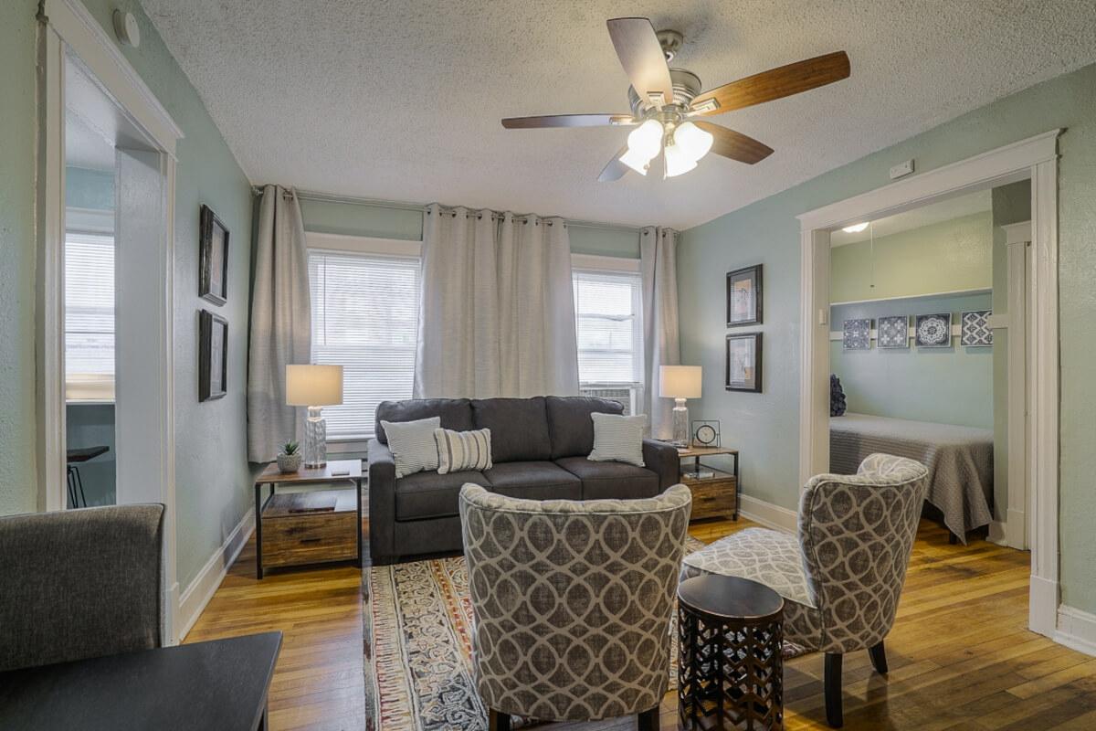 The living room at 3721 Broadway Blvd has hardwood flooring and large windows.