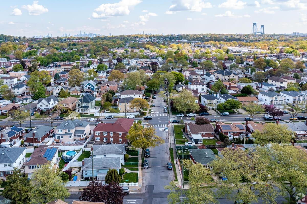 An aerial view of Staten Island with the Manhattan skyline in the distance.