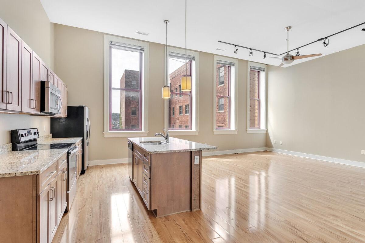 Units at Fifth Avenue School Lofts have modern appliances and finishes, contrasting the 19th-century architecture.