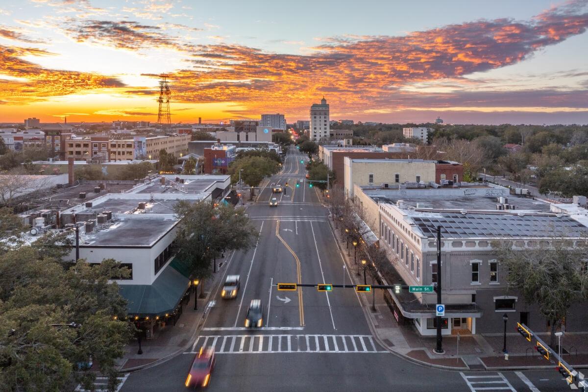 A stretch of road in Downtown Gainesville leads fades into the sunset.
