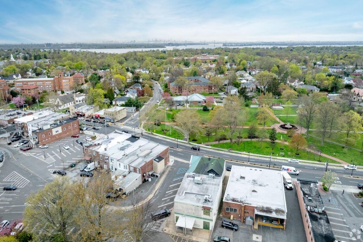 Trees and greenery fill in the space between buildings in Great Neck.