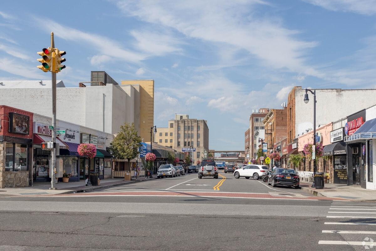 A street in Downtown Rockville Centre is lined with cars.