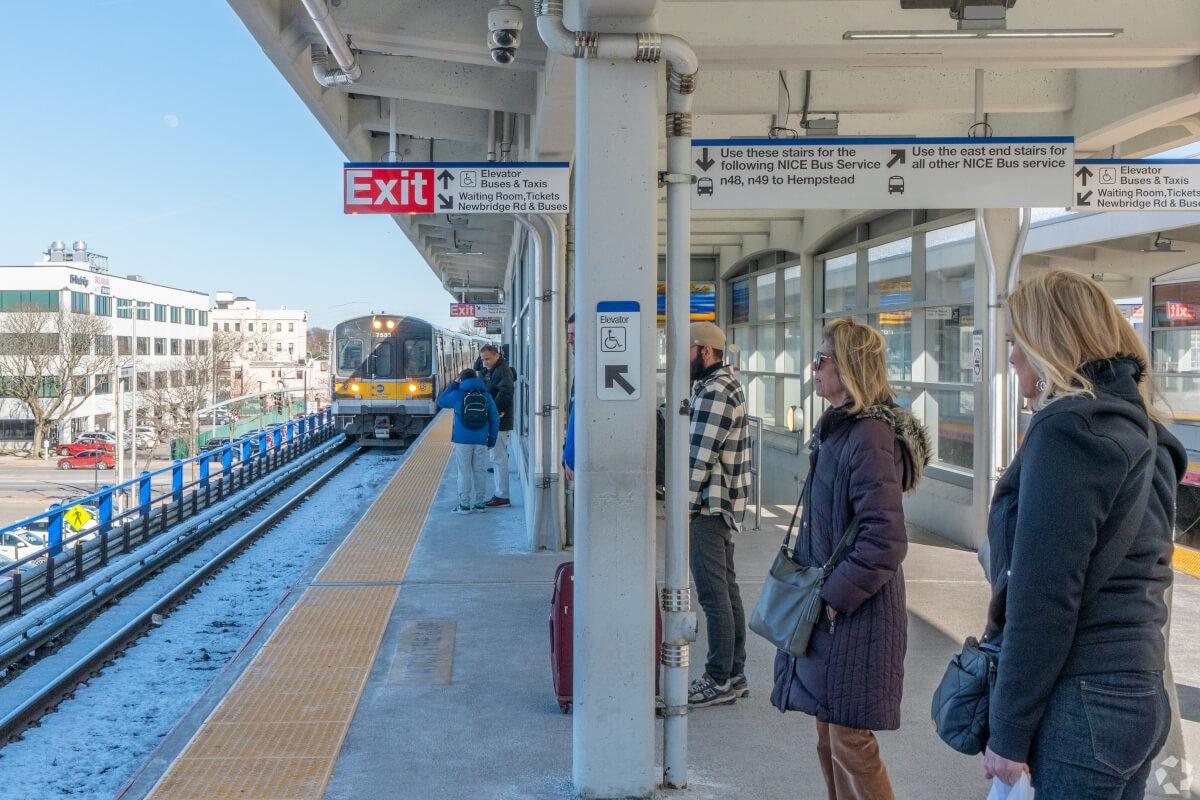 People waiting for the train at a station.