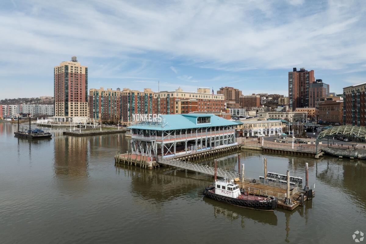 The Yonkers waterfront is full of tall buildings and a historic sign.