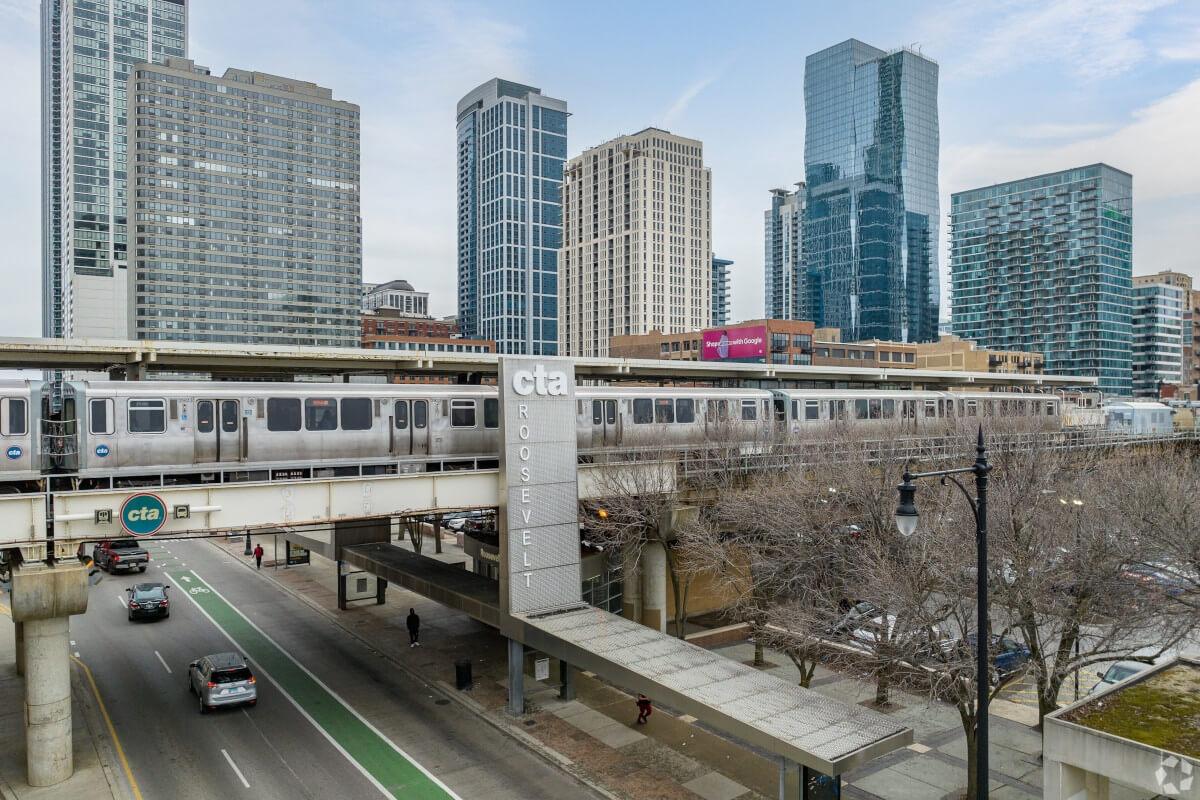 A CTA train travels over a road in South Loop.