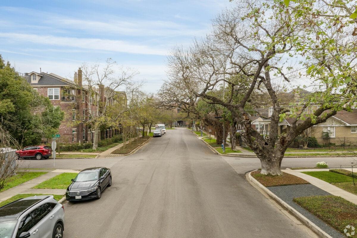 A wide street in Montrose, one of Houston's most beloved neighborhoods, is lined with trees.