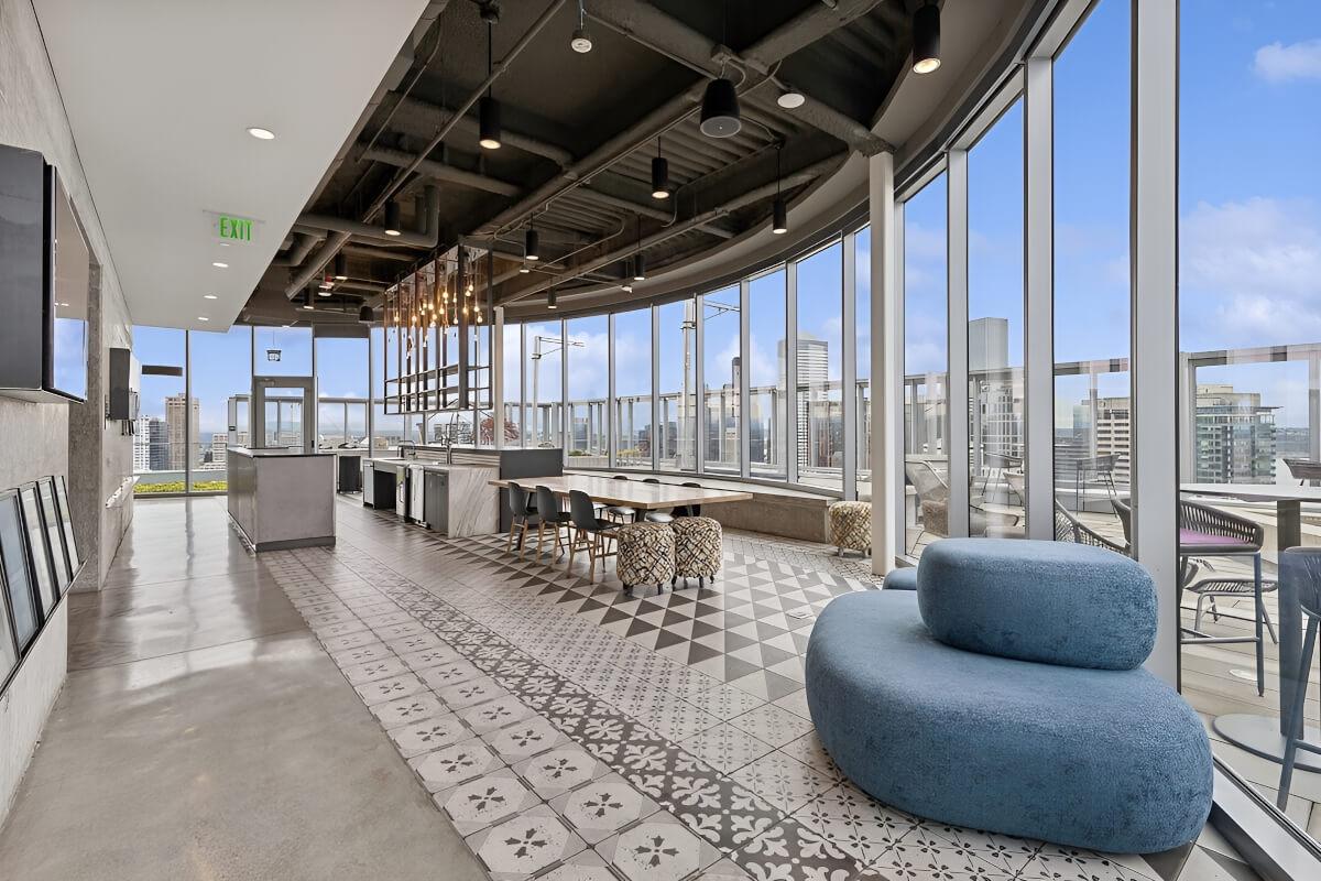 A huge rooftop kitchen is in a room with floor-to-ceiling windows.