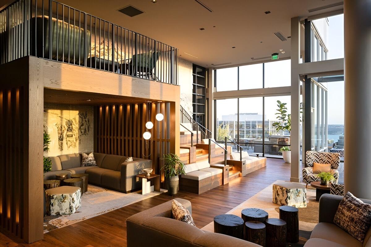 The modern rooftop lounge in The Ayer has high and low seating areas connected by wooden stairs that doubles as more seating.