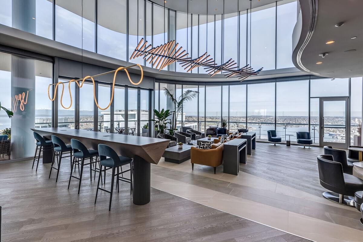 Tall glass windows surround the rooftop lounge.