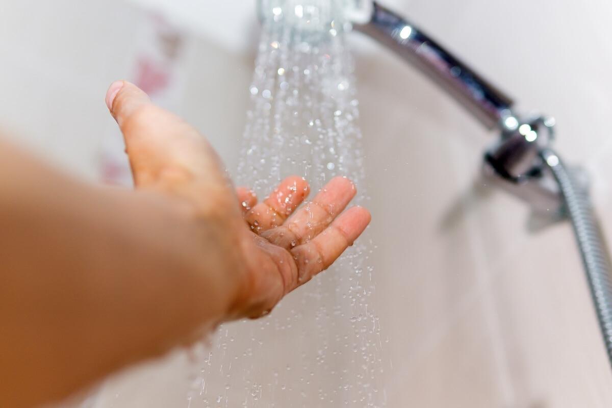 Person feeling the water pressure of a shower