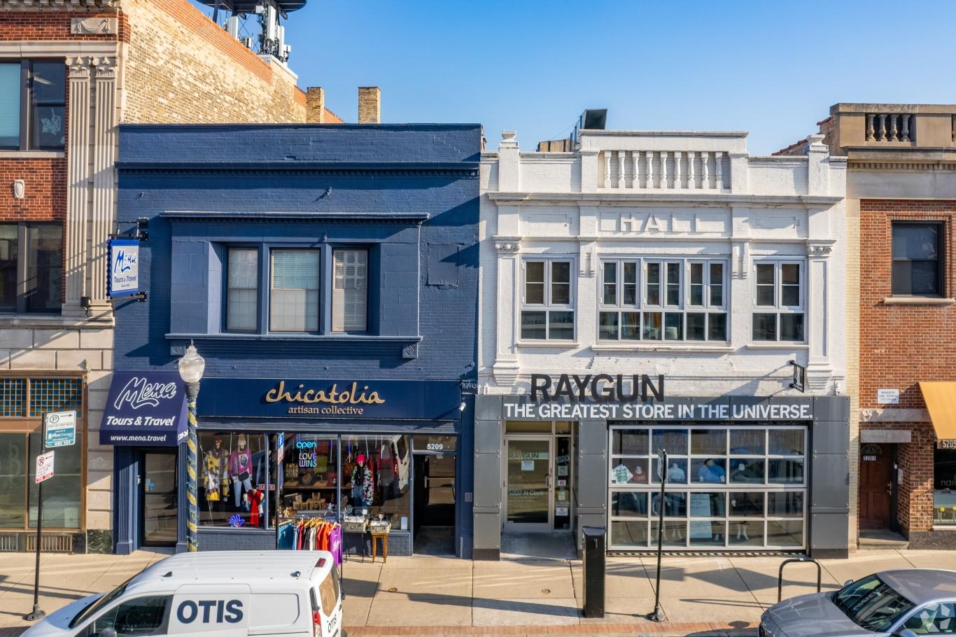 Street view in Andersonville featuring small boutique shops and a white van parked along the sidewalk.