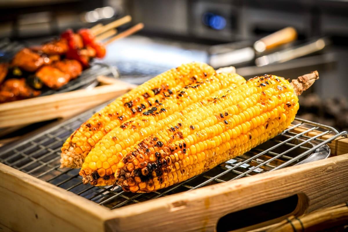 A close-up shot of grilled corn on the cob.