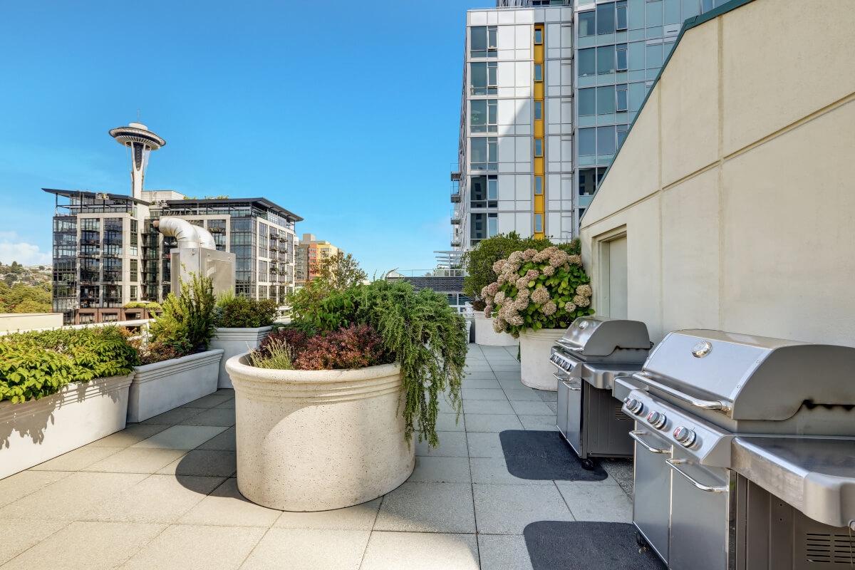 Large outdoor grills on the rooftop of an apartment building