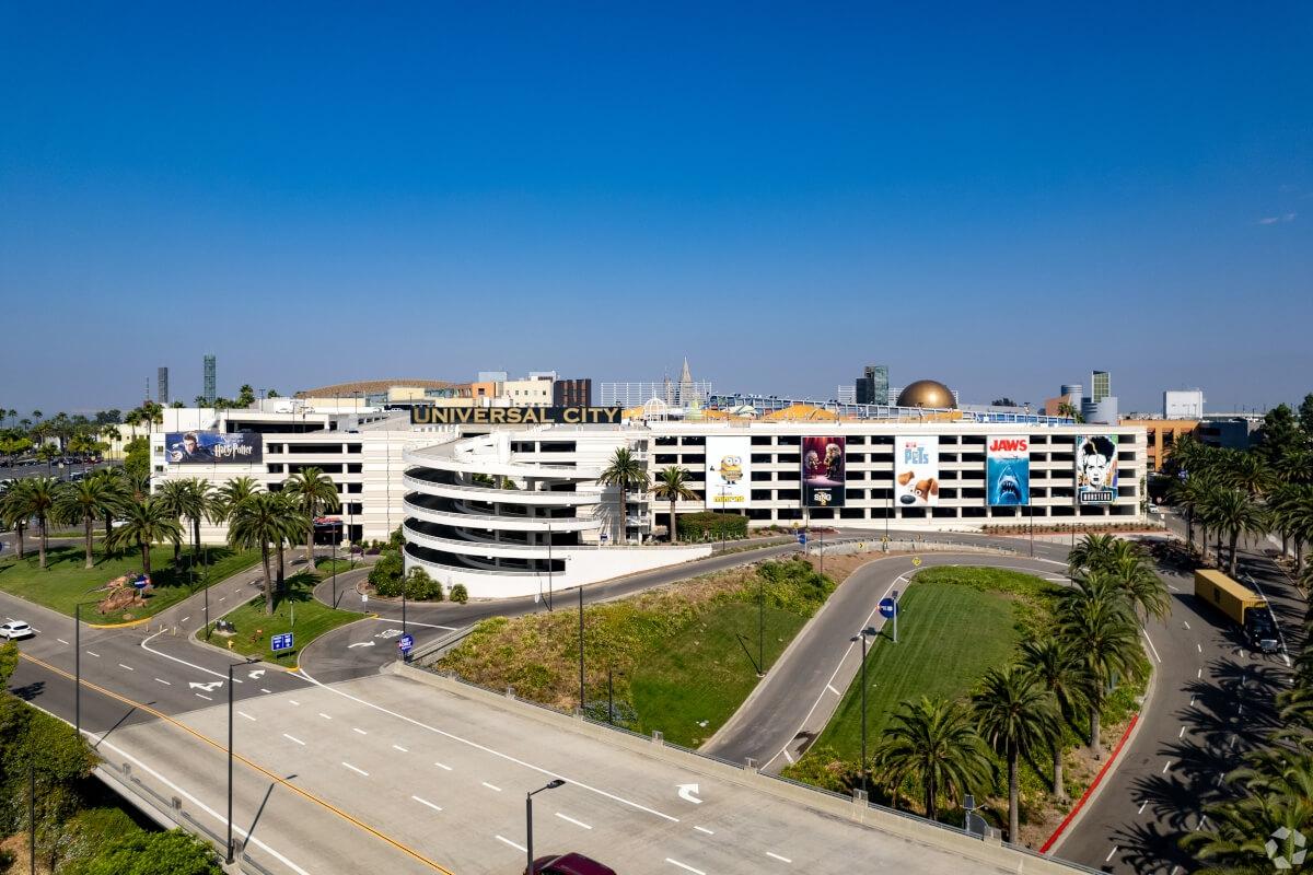 Universal Studios in Burbank, CA, is surrounded by palm trees.
