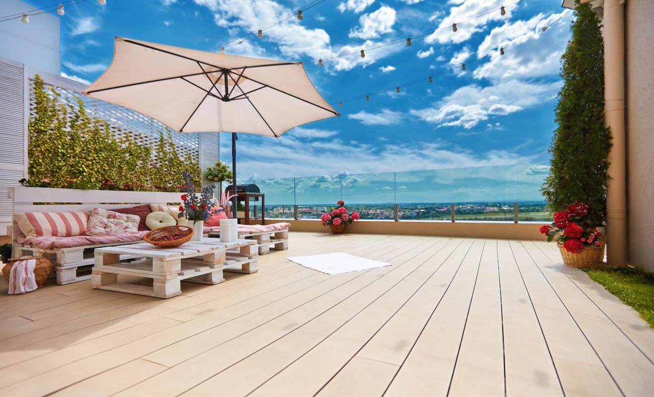 Lounge space with umbrella and sofa with a rooftop view