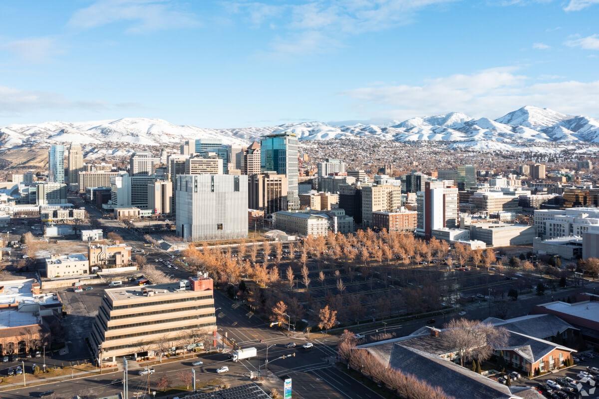 An aerial view of Central City with snowy mountains in the background.