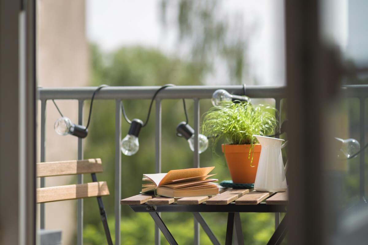 A view of an open book on a patio table.