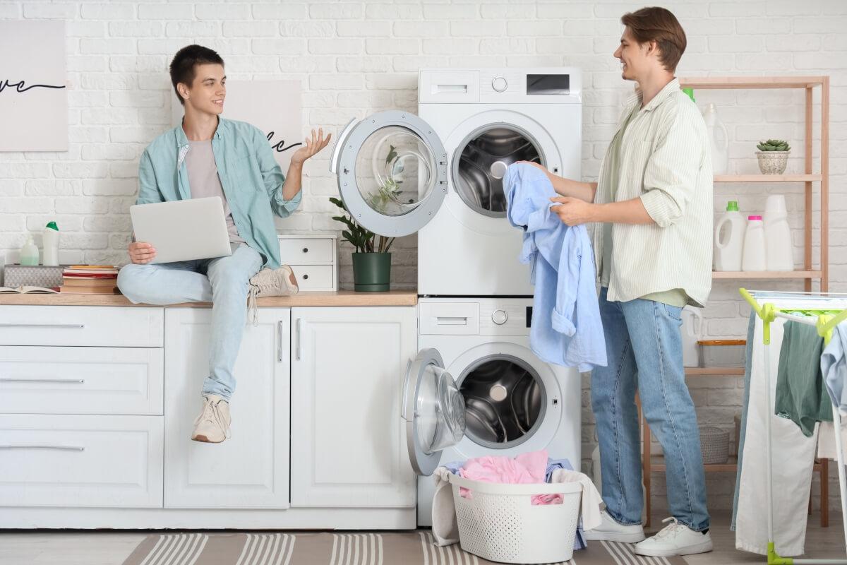 Two male students doing laundry.