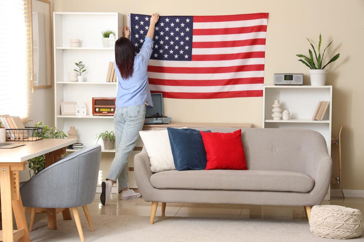 Renter hangs up Fourth of July decor for her apartment party.
