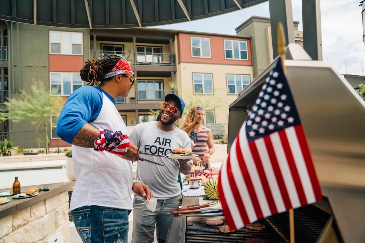 Apartment tenants grill out in a common area.
