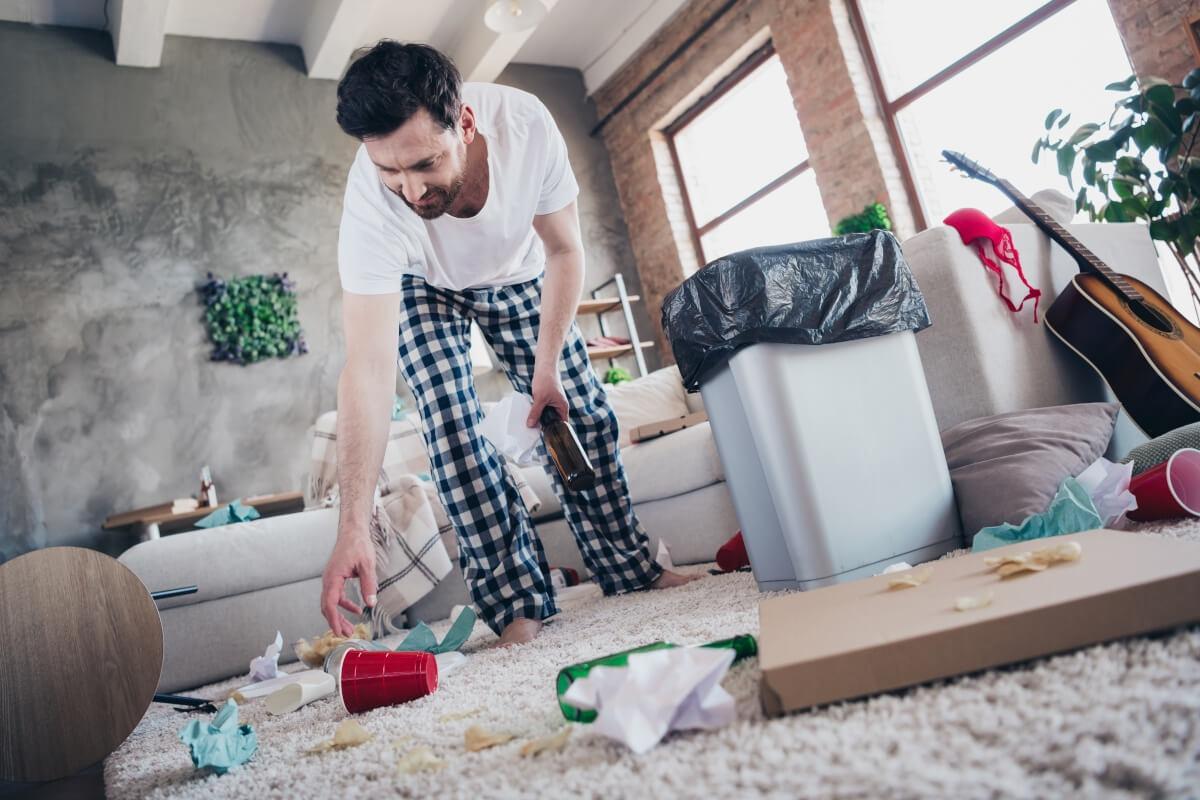 Tenant cleans up apartment after party.