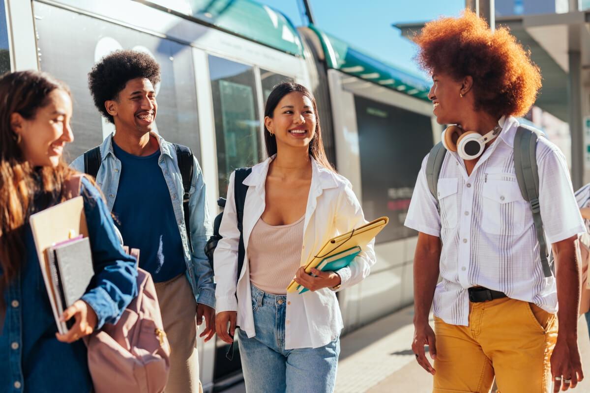 Students chatting next to public transportation.