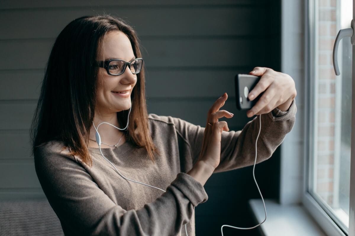 A property manager shows the window view of a rental while on a video call with a potential tenant.