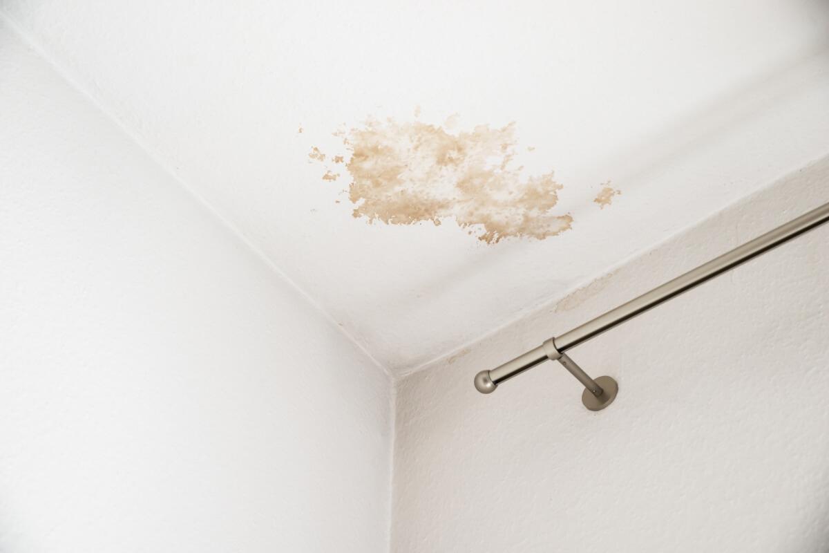 Water damage on the ceiling of a room in an apartment.