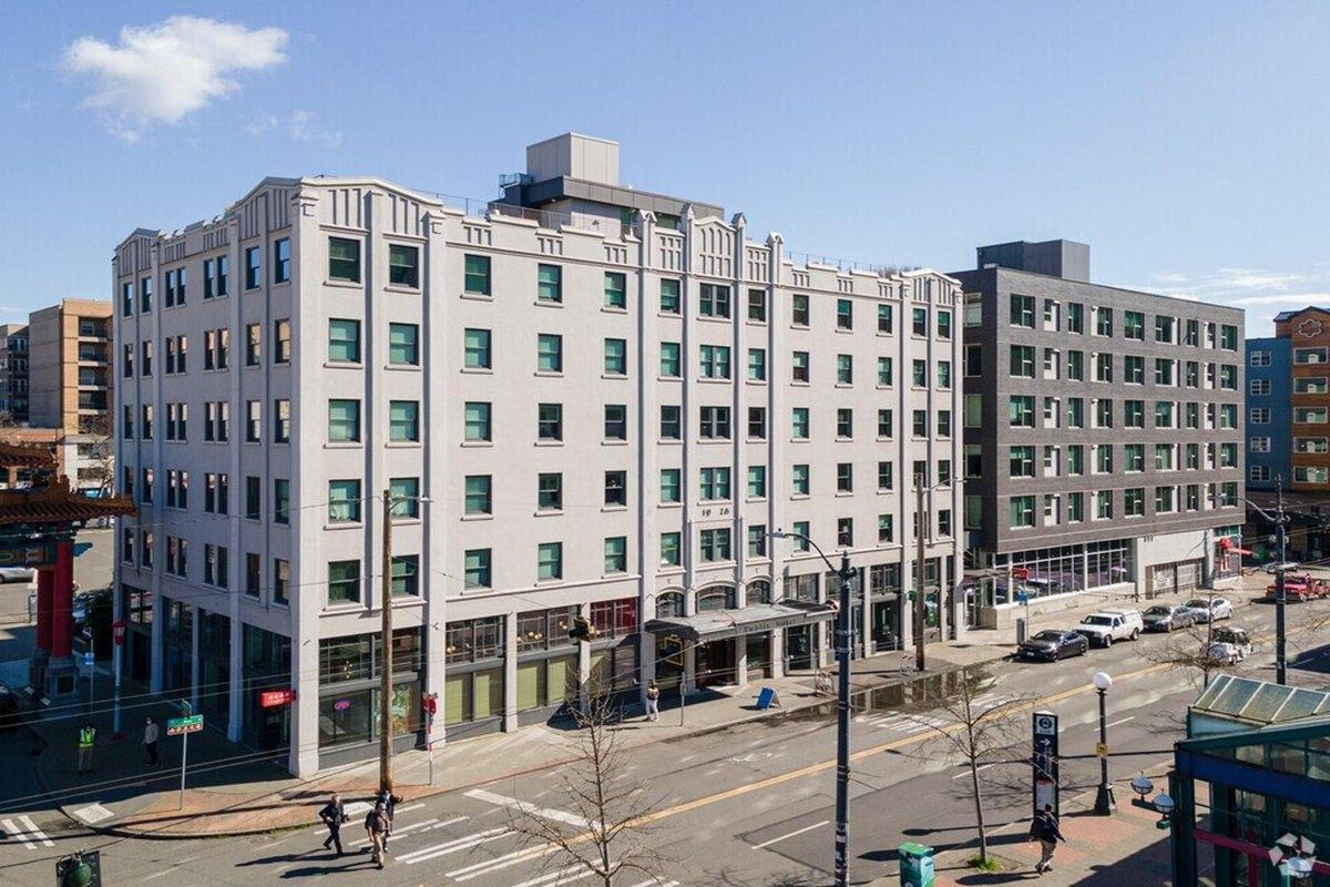 The Publix building in Seattle’s International District, featuring mixed-use apartments in a historic mid-rise with retail storefronts.