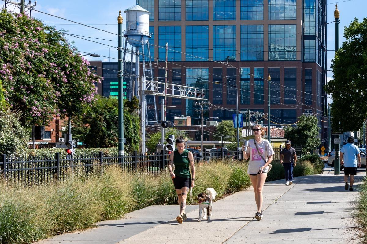 South End Rail Trail in Charlotte NC with people walking dogs and enjoying city views — ideal for pet-friendly apartments near public trails.