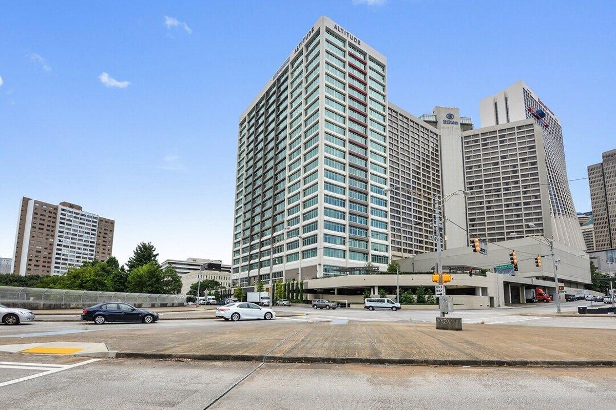Street-level view of a high-rise commercial tower, illustrating why large office buildings are prime candidates for urban residential redevelopment.