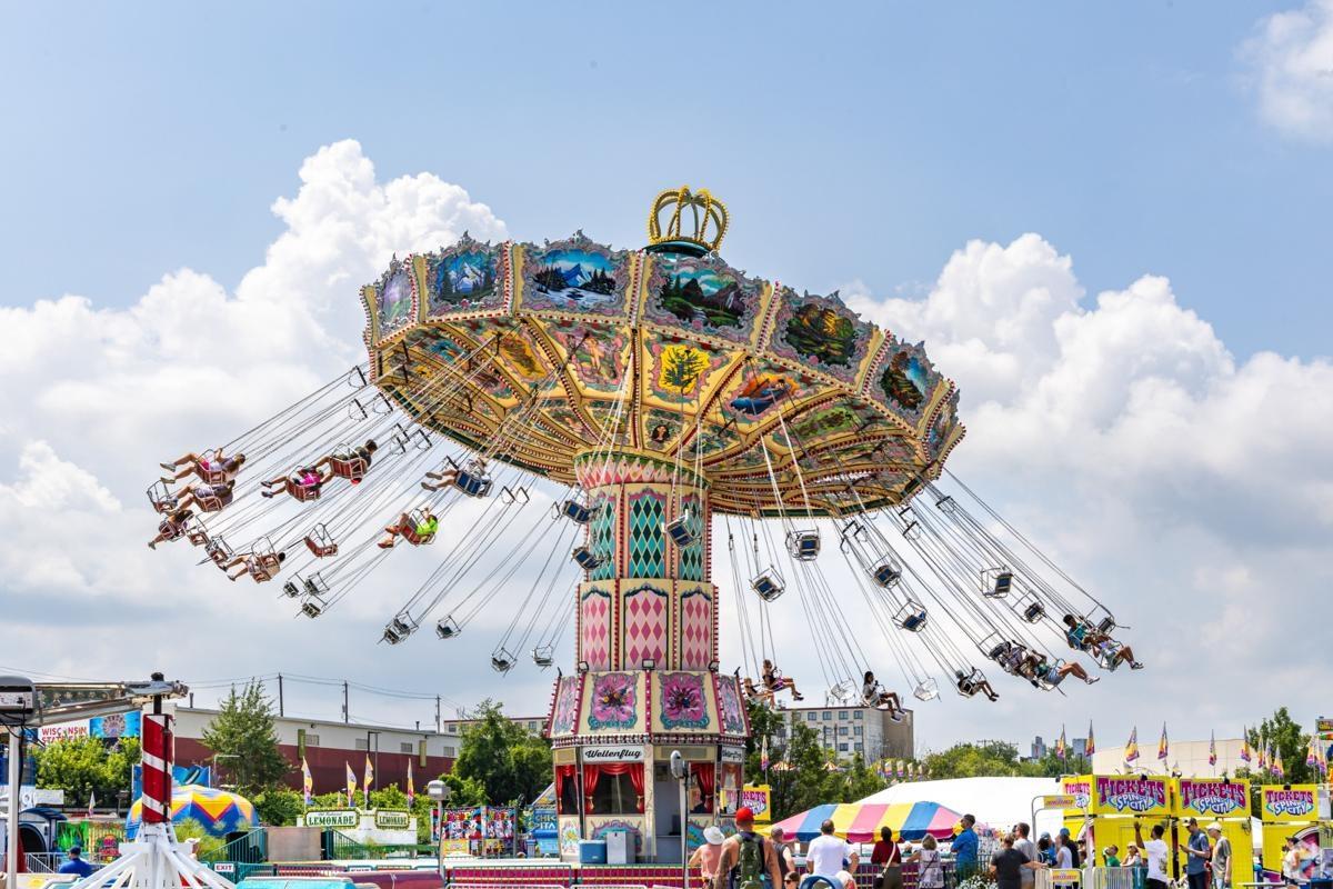  Colorful swing ride in motion at the Wisconsin State Fair, capturing vibrant summer fun near apartment communities in Milwaukee.