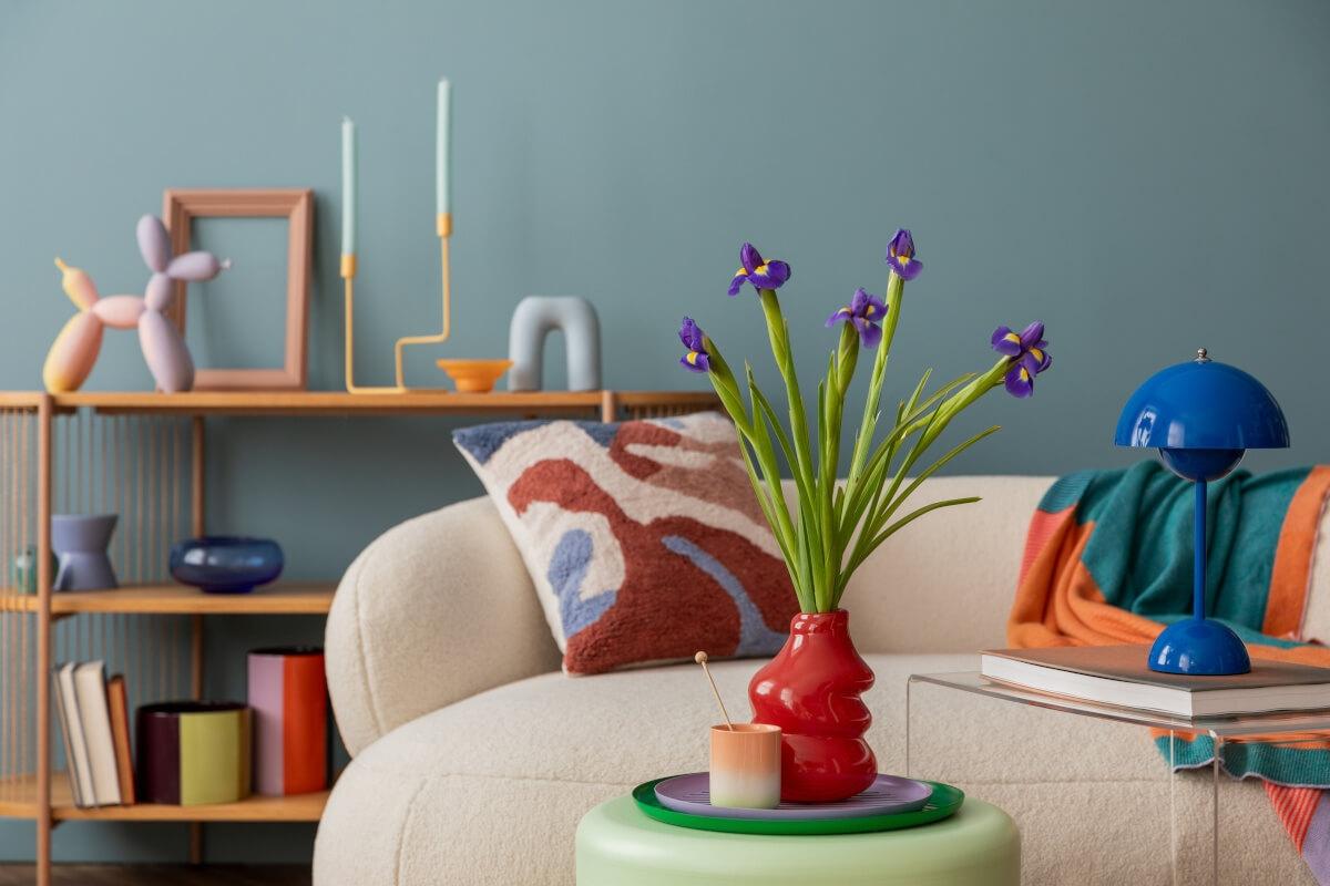 A view of a dopamine décor-style living room with quirky and colorful trinkets.
