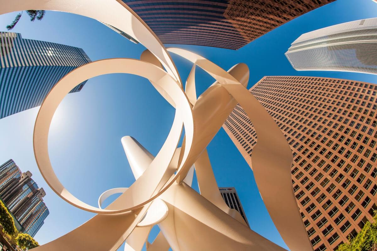 Skyscrapers surrounding a metal arts sculpture