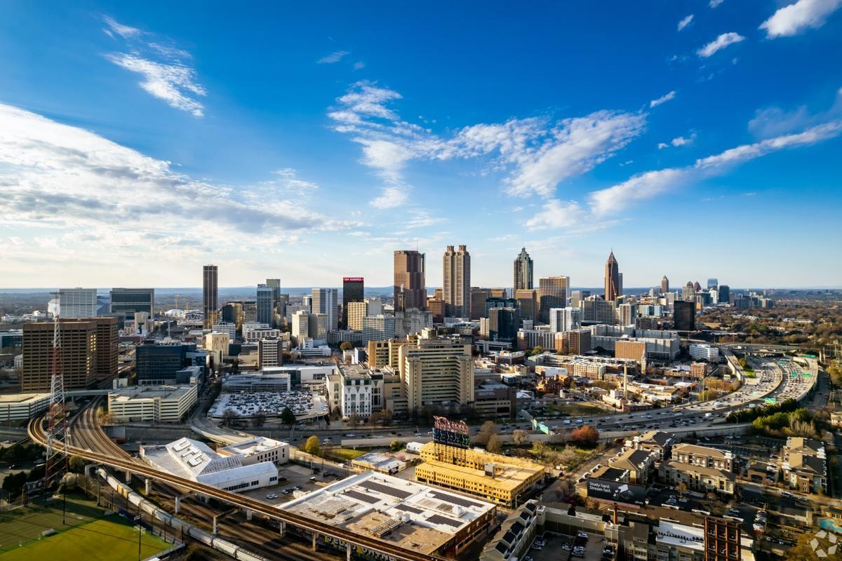 Expansive view of Atlanta, Georgia with high-rise apartments and business towers surrounding the I-75/I-85 corridor.