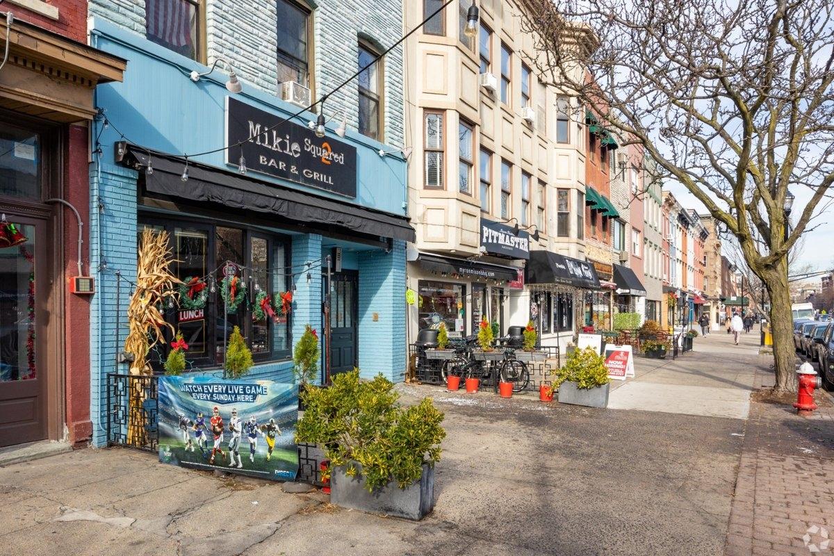 Charming Hoboken, NJ street with bars, boutiques, and townhomes — great for renters desiring a lively, walkable neighborhood near NYC.