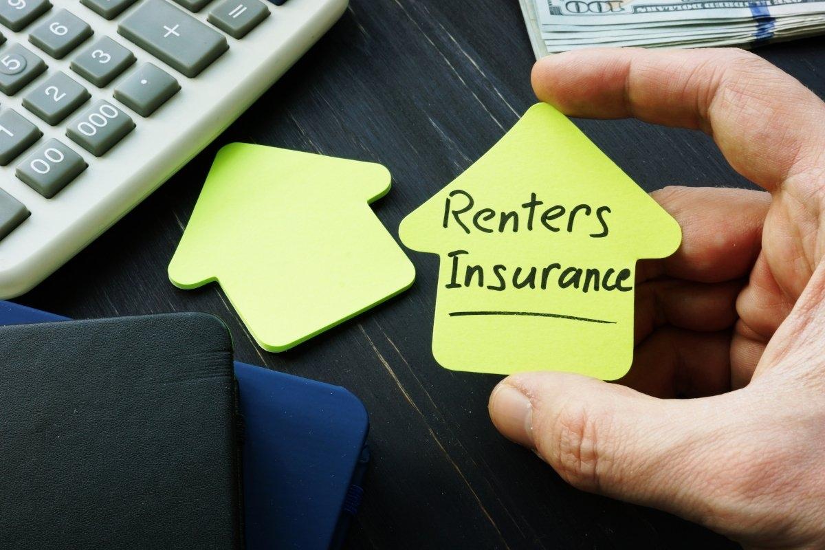 Sticky note shaped like house with "renters insurance" written on it.