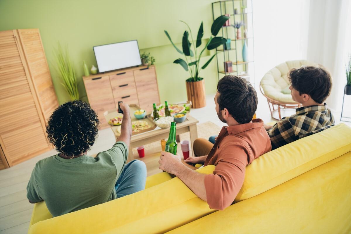 Apartment goers watch football game together.