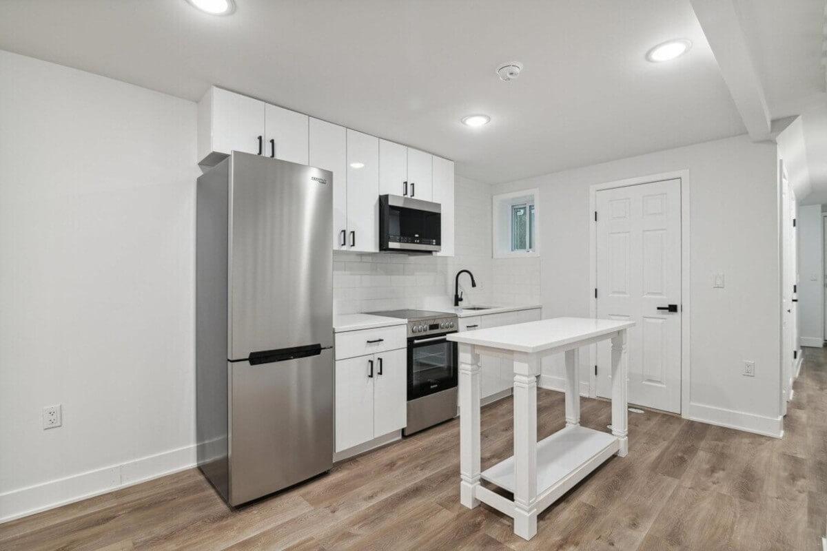 A view of the kitchen at 36 Park St Unit 1 shows a white island.