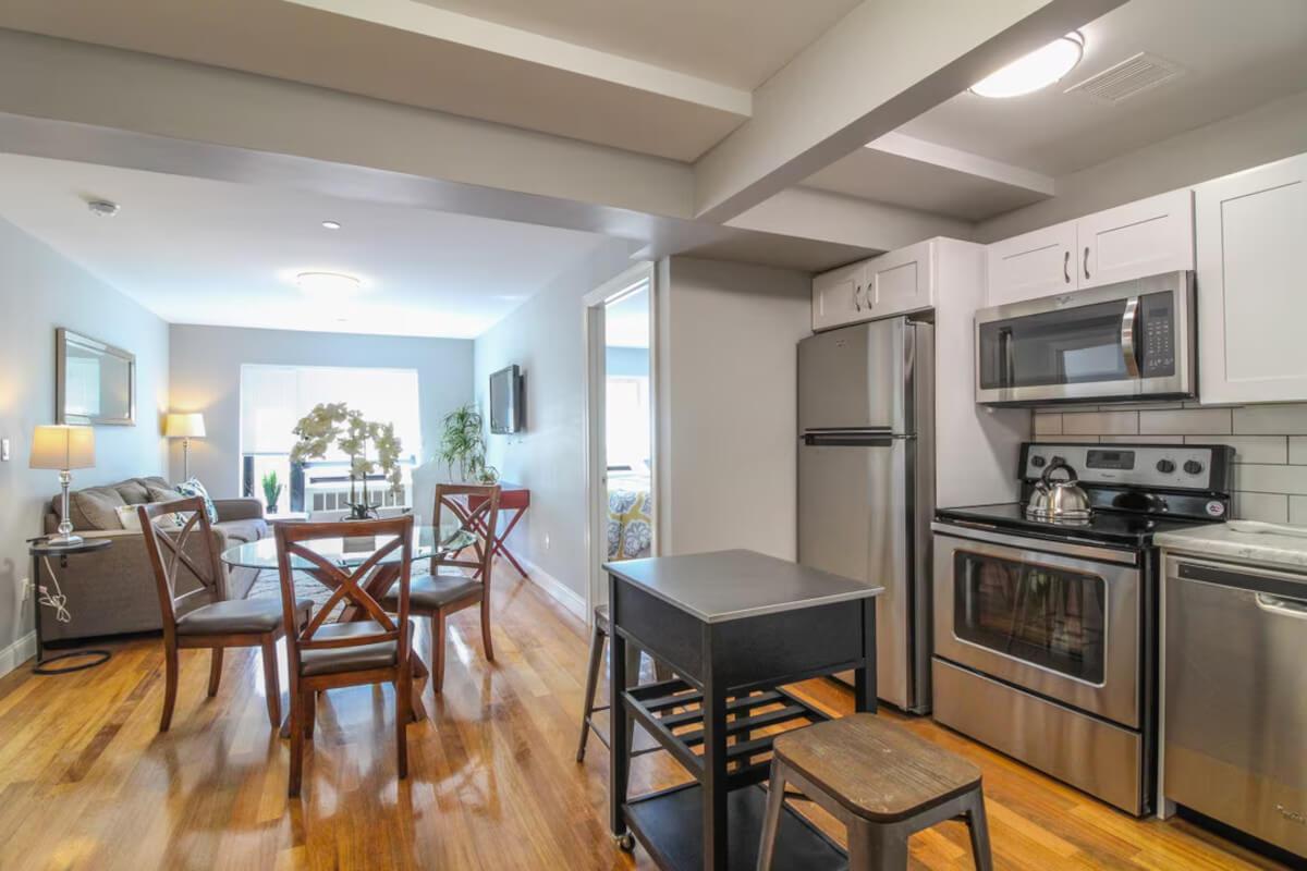 A model unit at The Equestrian At Pelham Parkway shows an open-concept living and dining area.