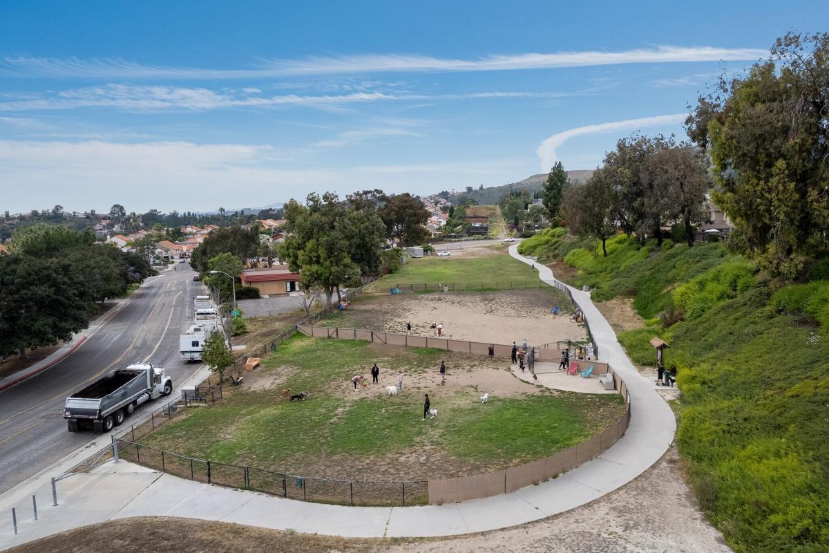 Aerial view of Rancho Peñasquitos Dog Park, highlighting large fenced-in areas near residential neighborhoods for apartment communities.