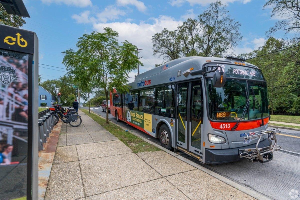 A large bus sitting at a bus stop in DC