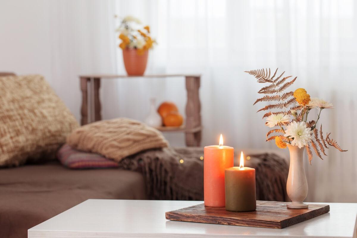 Living room with lit candles, contributing to the fall ambiance 