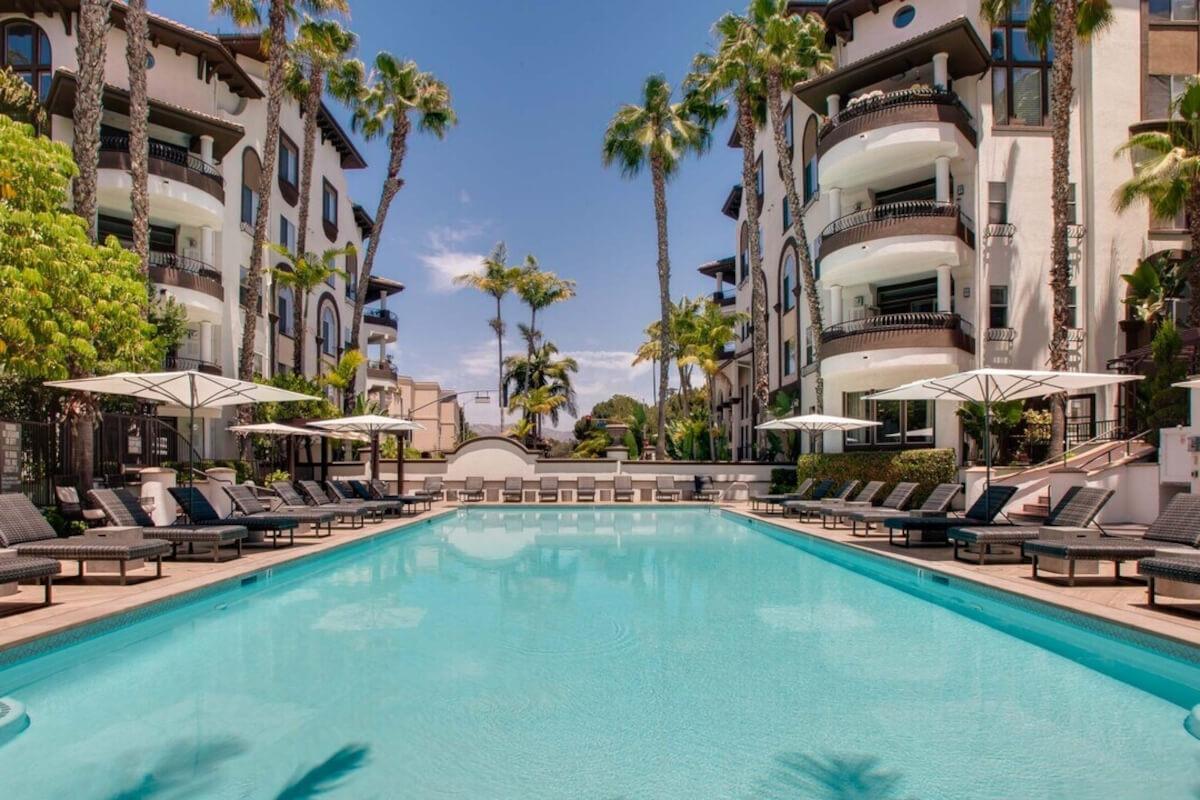 Saltwater pool surrounded by lounge chairs at the luxury apartment community, Palazzo West.