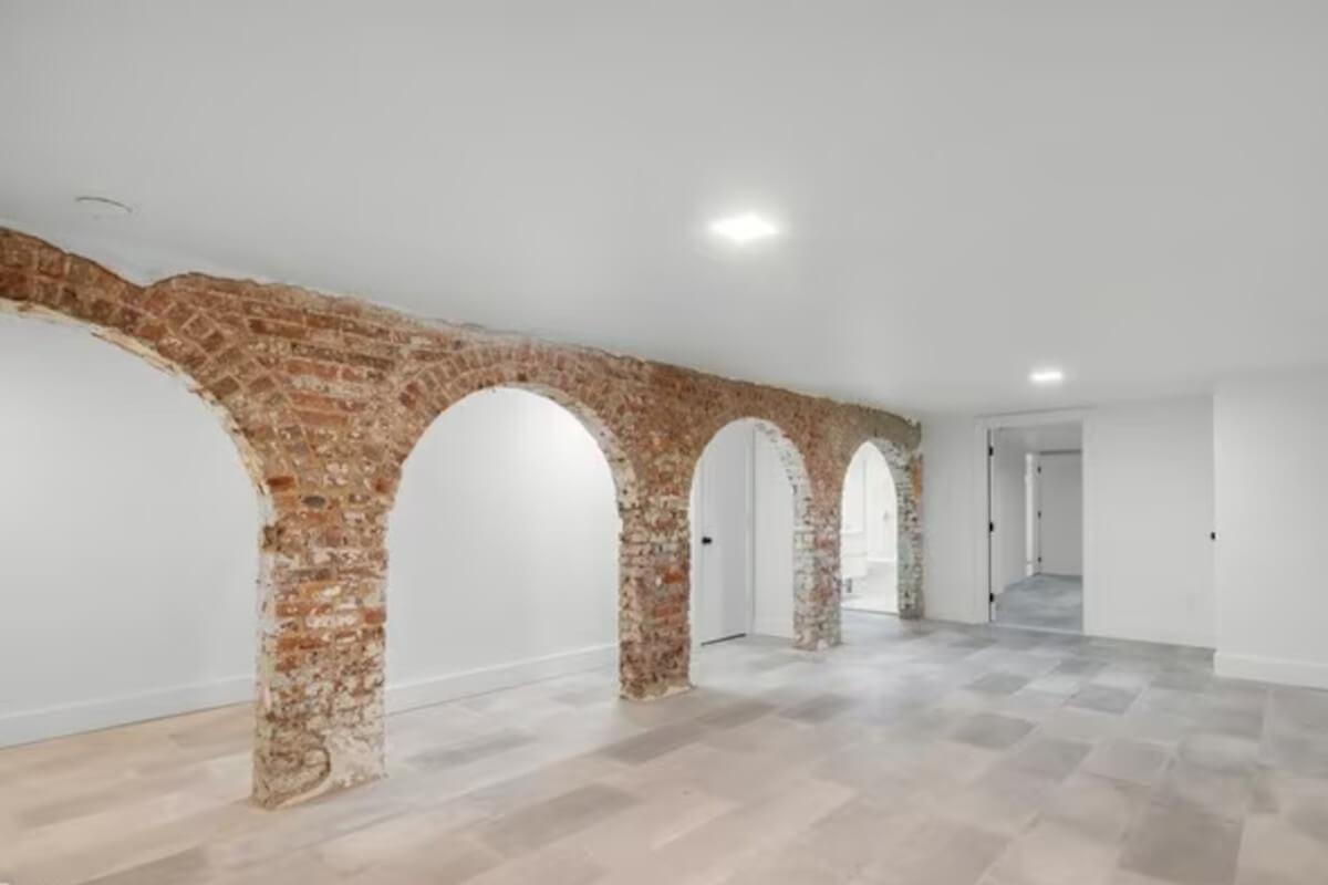 The lower level of 165 Monroe Street has an open-concept layout and exposed brick arches.