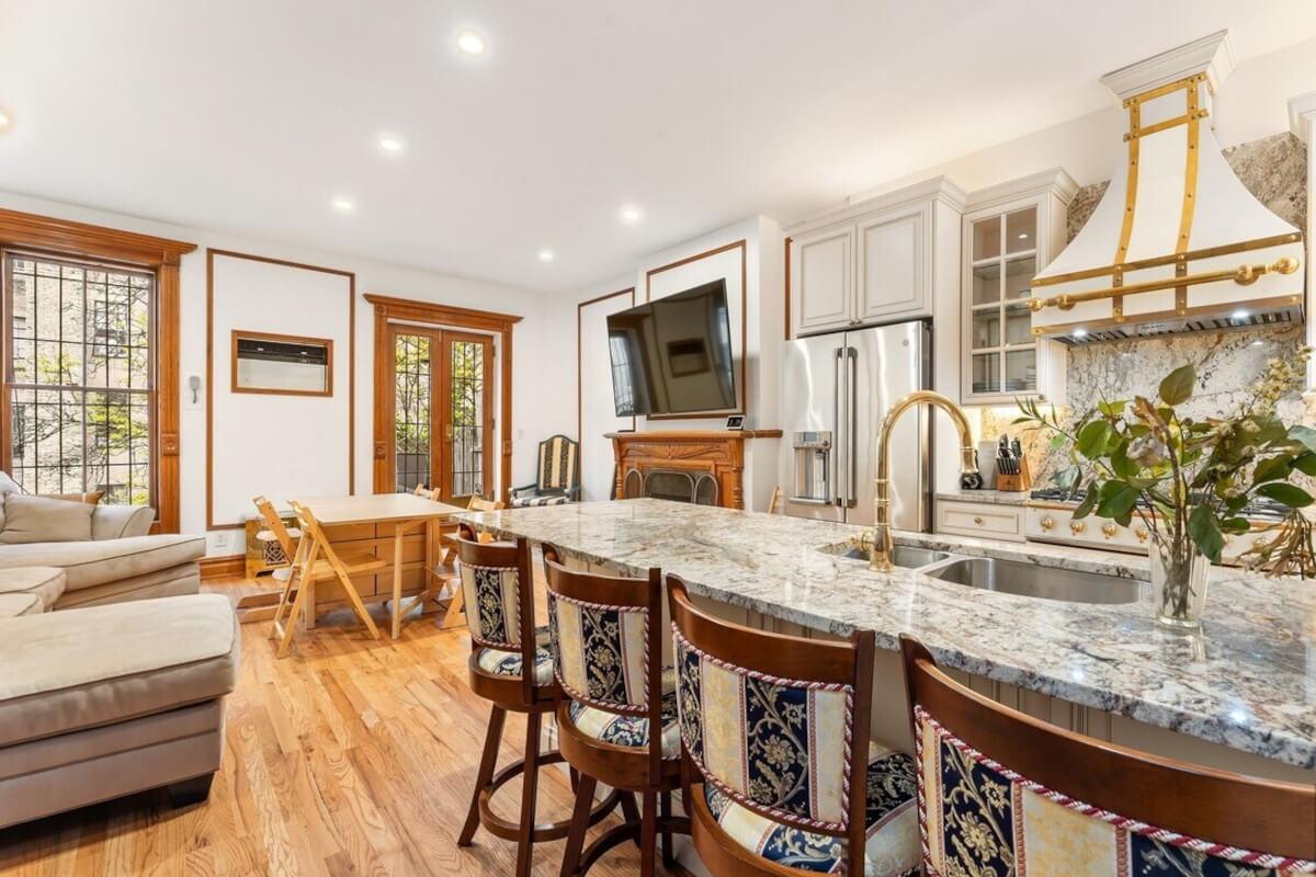 The kitchen at 44 West 91st Street in Manhattan has gold finishes and granite countertops.
